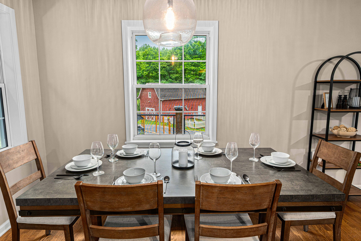 Dining Space: Gather around the stylish table and enjoy scenic views of the green hills!