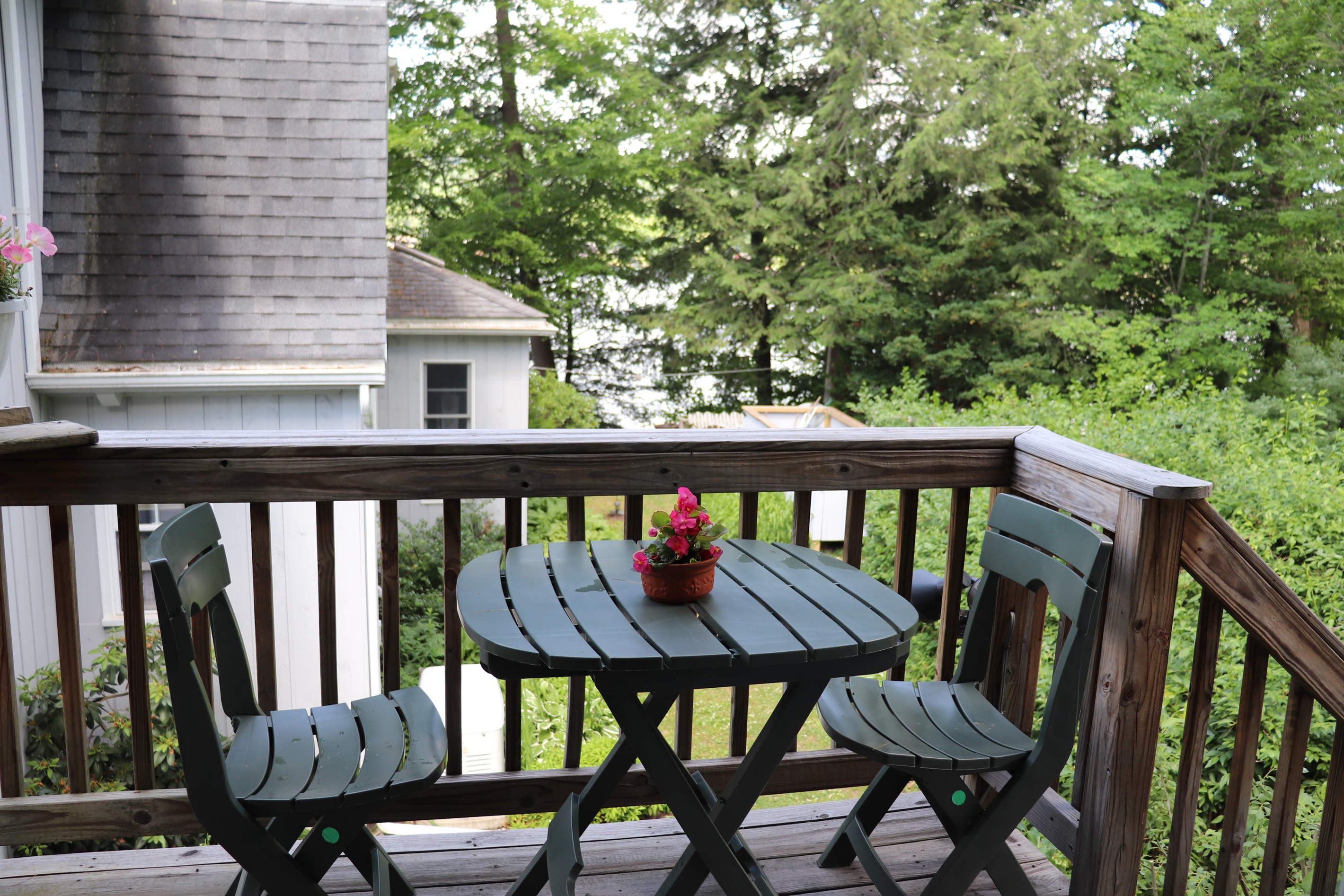 Outdoor seating area on private balcony, see the lake through the trees!
