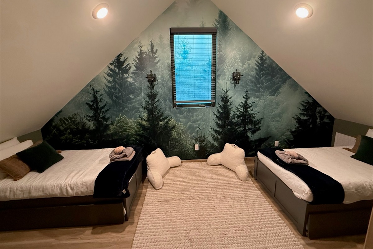 Get lost in the forest, in this cozy upstairs retreat that sleeps 4 with 2-twin trundle beds.