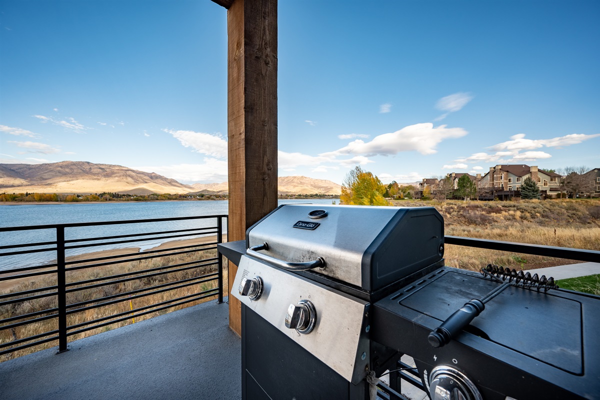 Private balcony with gas grill and sweeping lake and mountain views.