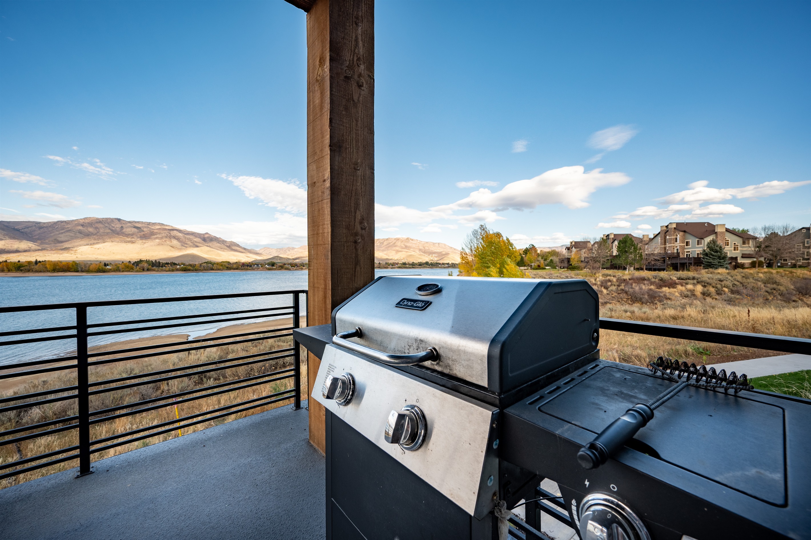 Private balcony with gas grill and sweeping lake and mountain views.