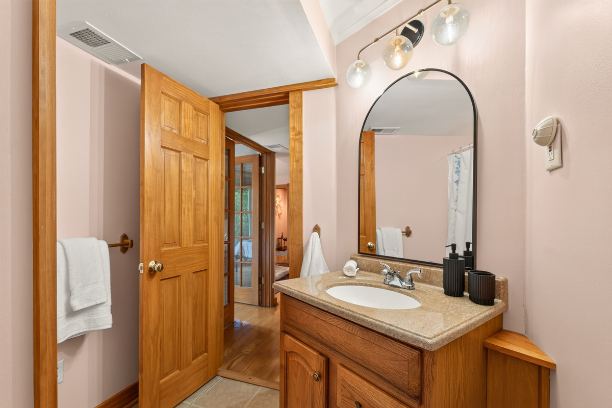 Bathroom vanity beneath a framed mirror