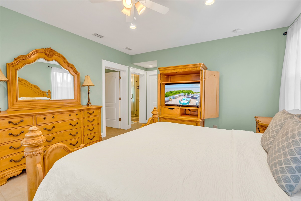 The primary includes a king sized bed and TV.