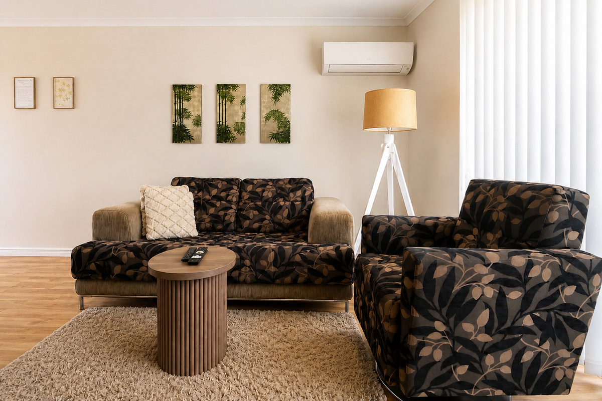The living area includes comfortable seating, air-conditioning and TV space, giving Sea Breeze Apartment a practical place to unwind between Mandurah outings.