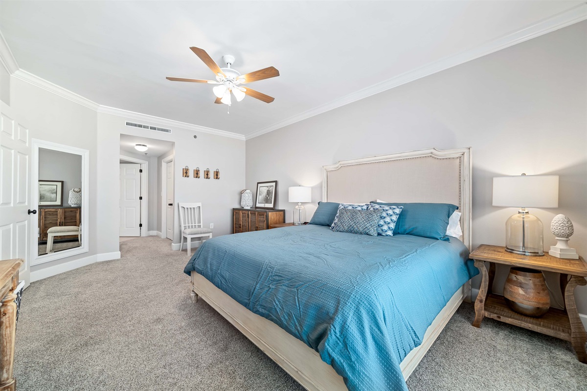 Enjoy the perfect blend of comfort and coastal beauty in this inviting bedroom with direct balcony access and stunning bay views.
