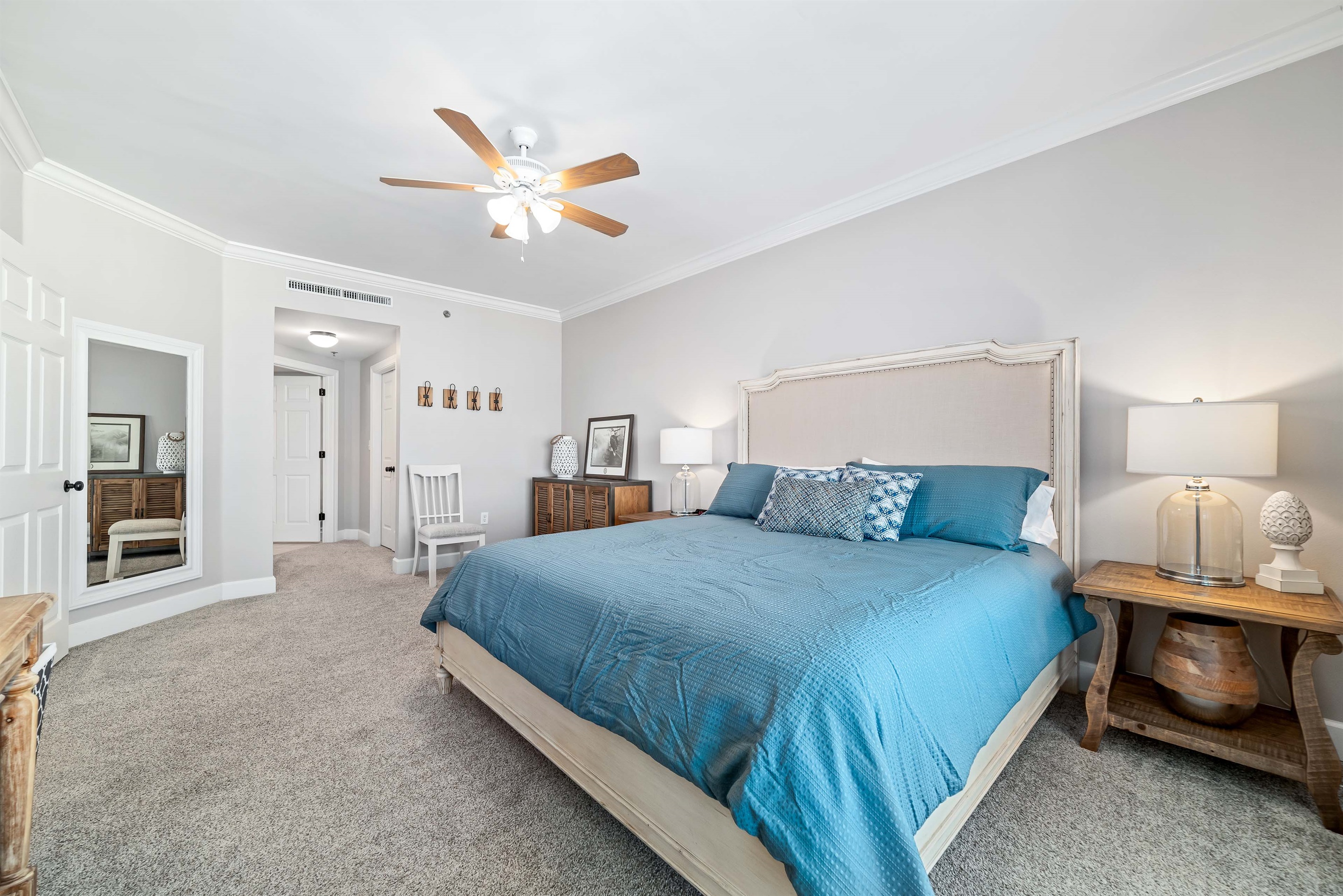 Enjoy the perfect blend of comfort and coastal beauty in this inviting bedroom with direct balcony access and stunning bay views.