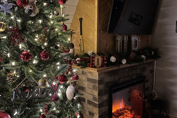 Sit on the couch by the fireplace and enjoy the beauty of the tree decorated for the holidays, while the snow falls outside.