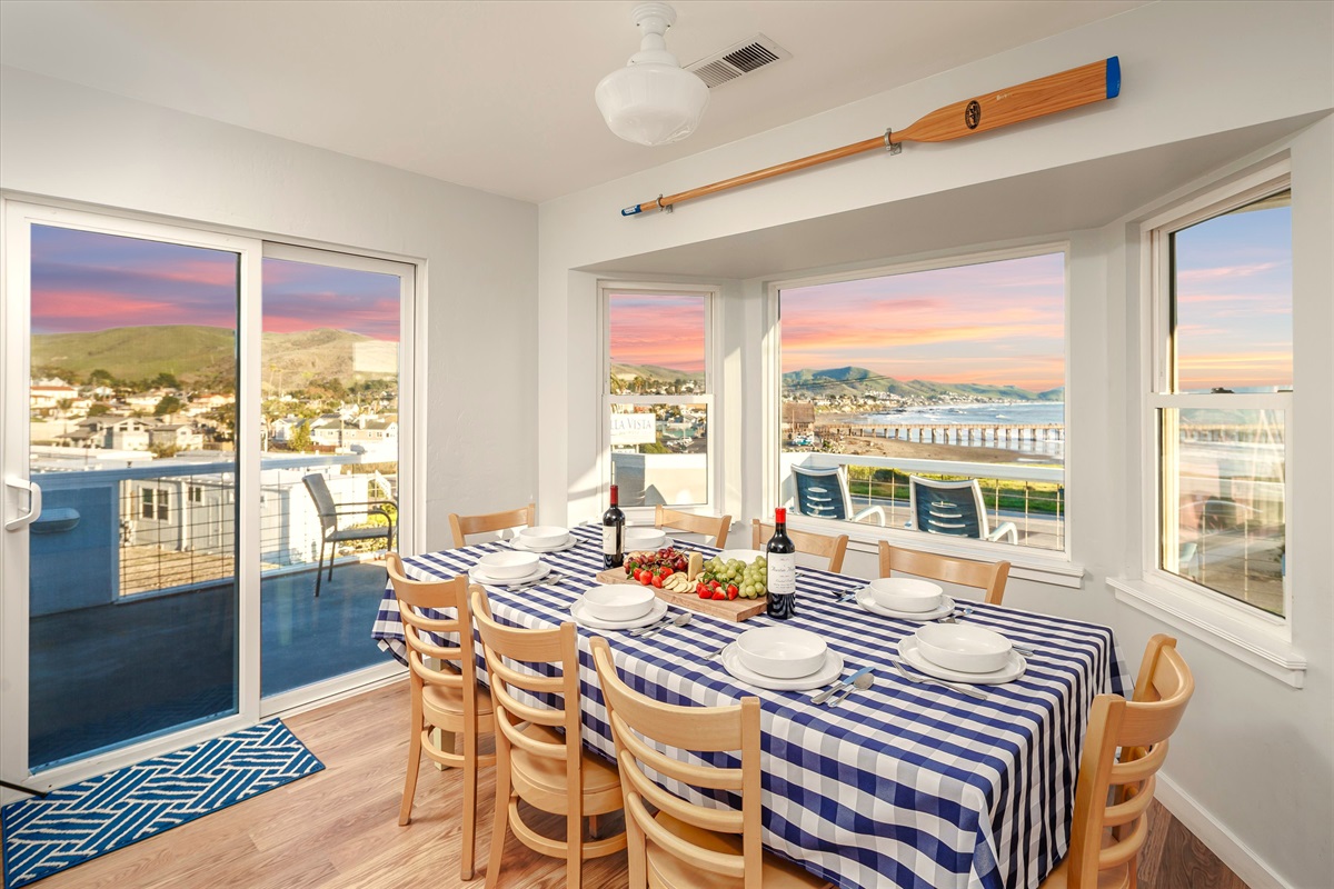 A big, welcoming kitchen and dining space made for cooking together, lingering over meals, and sharing stories from the day while enjoying the view of the ocean and hillsides.