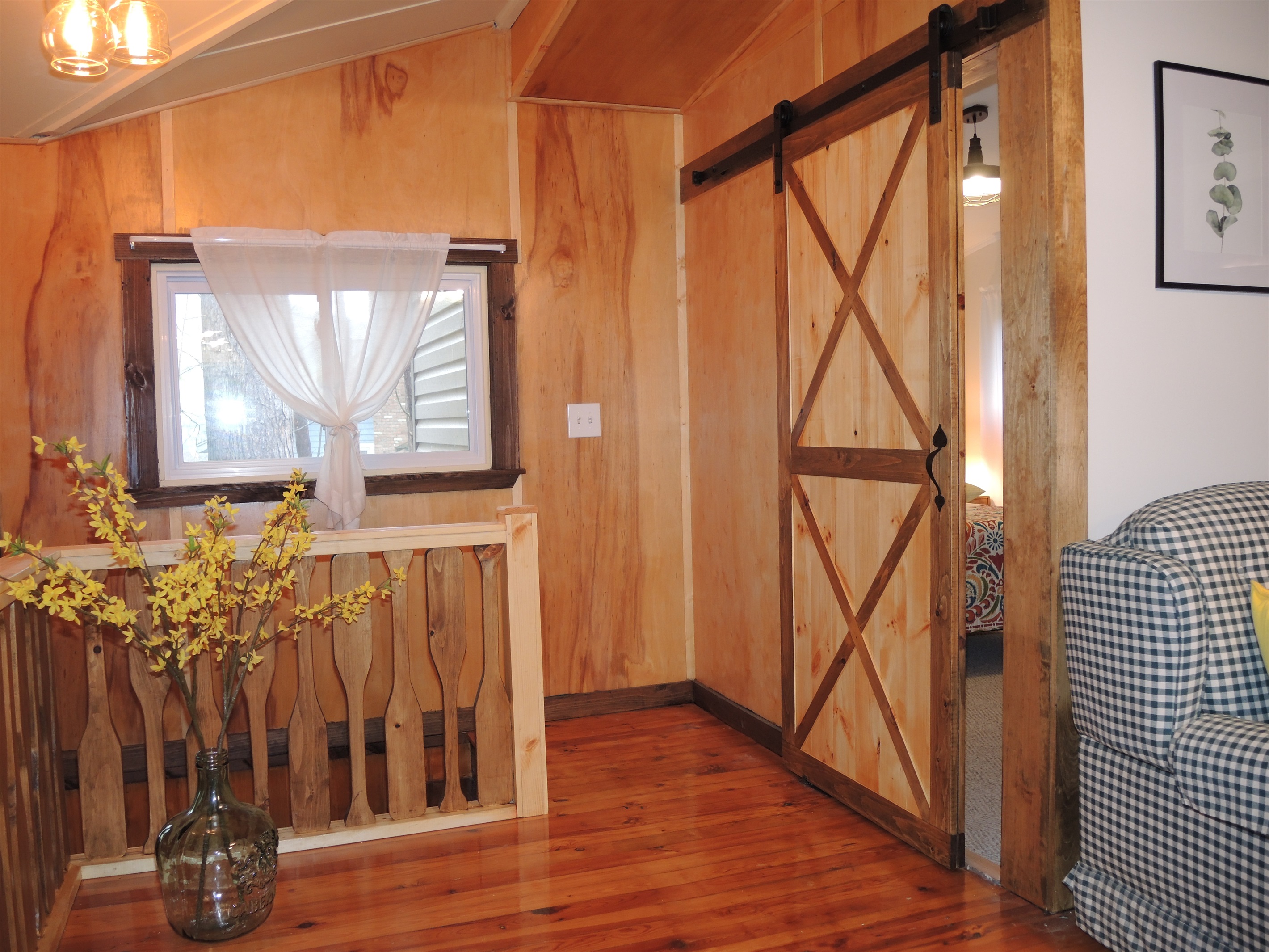 Living area with barn door to Queen bedroom