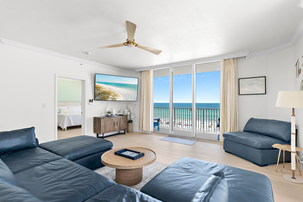Large, Open Living Room with Gulf Views through Floor-to-Ceiling Sliding Doors, Patio Access, 75" Smart TV, and all New Leather Living Room Furniture