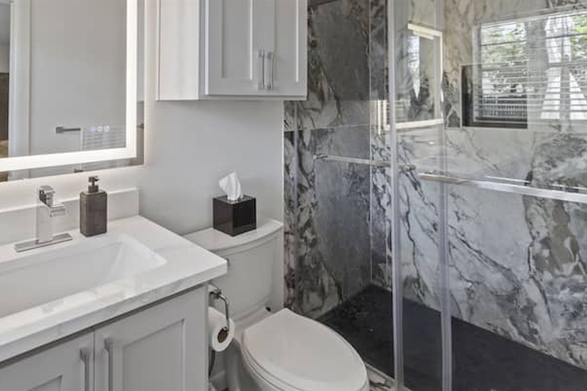 Walk-in shower with sleek finishes and a fresh spa-inspired feel.