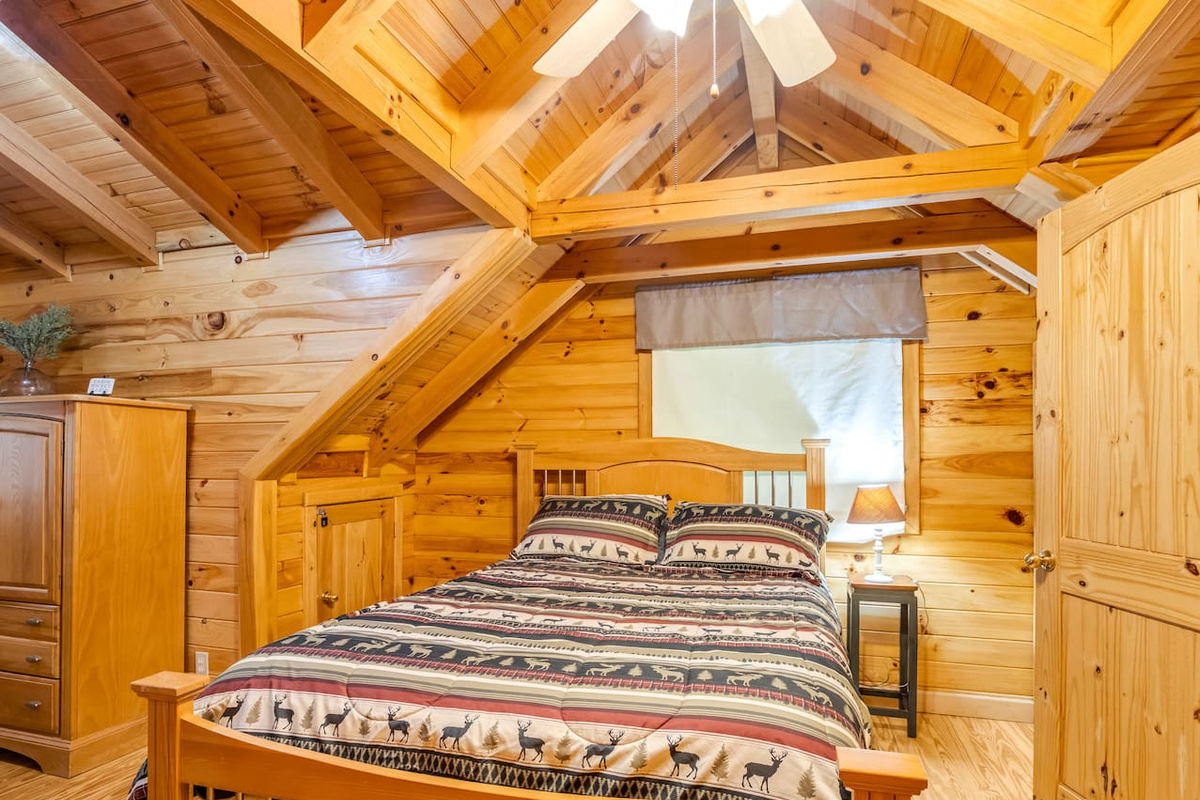 Bedroom on the third level of the property features a comfortable double bed, private bathroom, and plenty of storage space