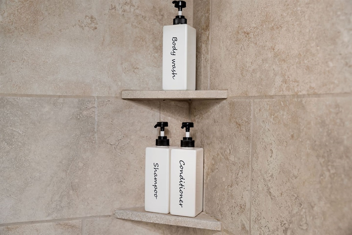 Refresh in the shower with provided body wash, shampoo, and conditioner. The neatly labeled bottles offer convenience and a touch of luxury.