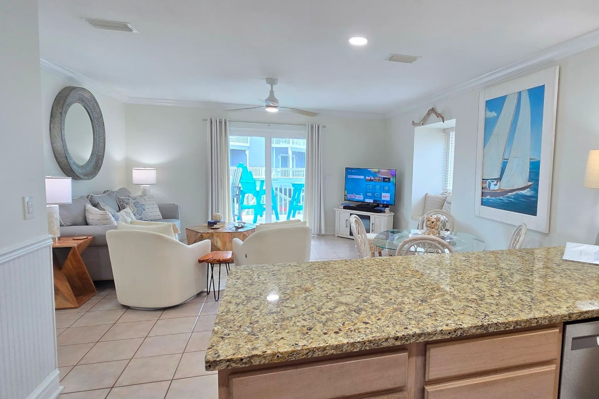 The open layout keeps everyone in the conversation &mdash; kitchen, dining, and living all flow together so nobody disappears into another room.