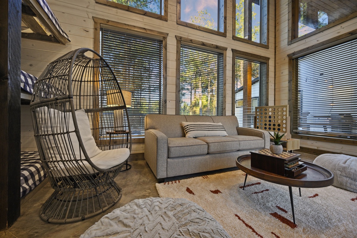 A bright and cozy sitting nook for reading, relaxing, or soaking in peaceful forest views.