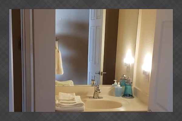 Bathroom next to bunk beds 