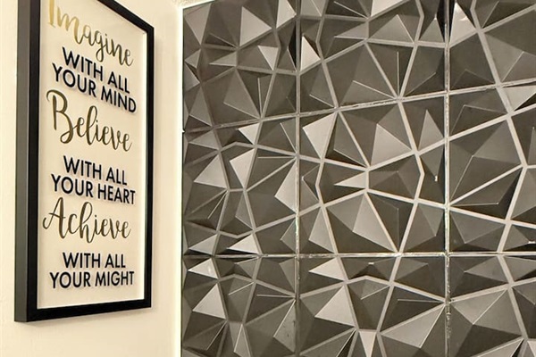Uplifting wall quote paired with textured tile — small details that make a big impression. 