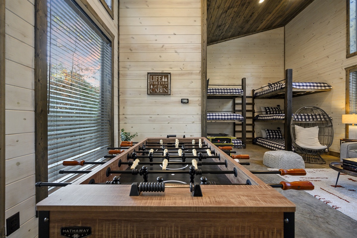 A cheerful game bunkhouse designed for connection and play, complete with foosball and room to relax.