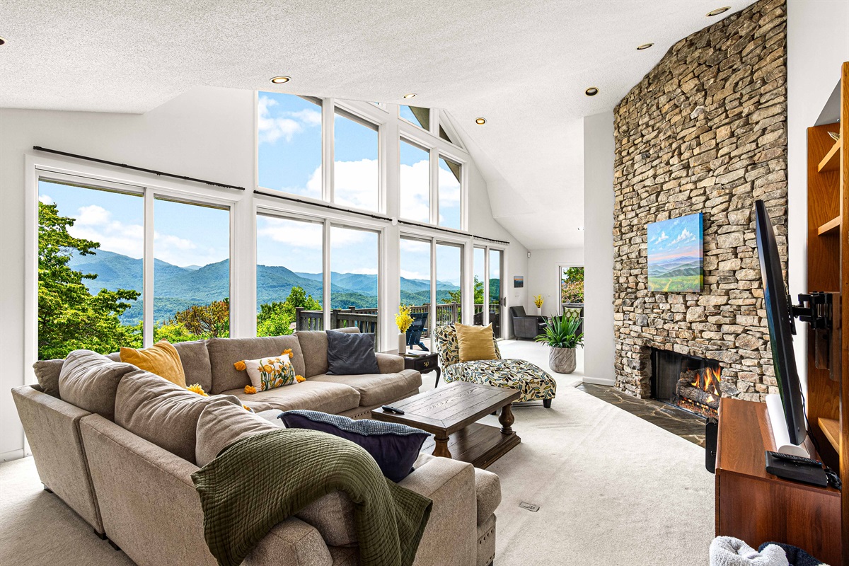 Living Room: Spectacular mountain views and a stylish stone fireplace create a perfect retreat!