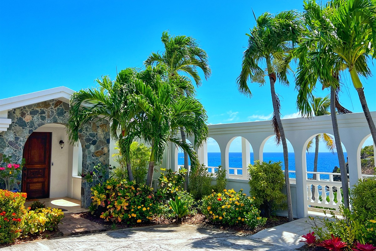 Take in the grandeur of the villa&rsquo;s exterior and palm-lined driveway.