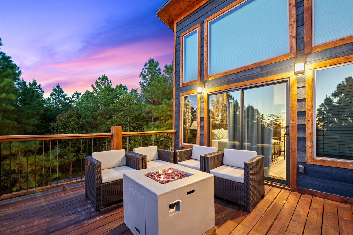 The fire table provides a warm and inviting spot to gather while gazing out over the beautiful forest views.