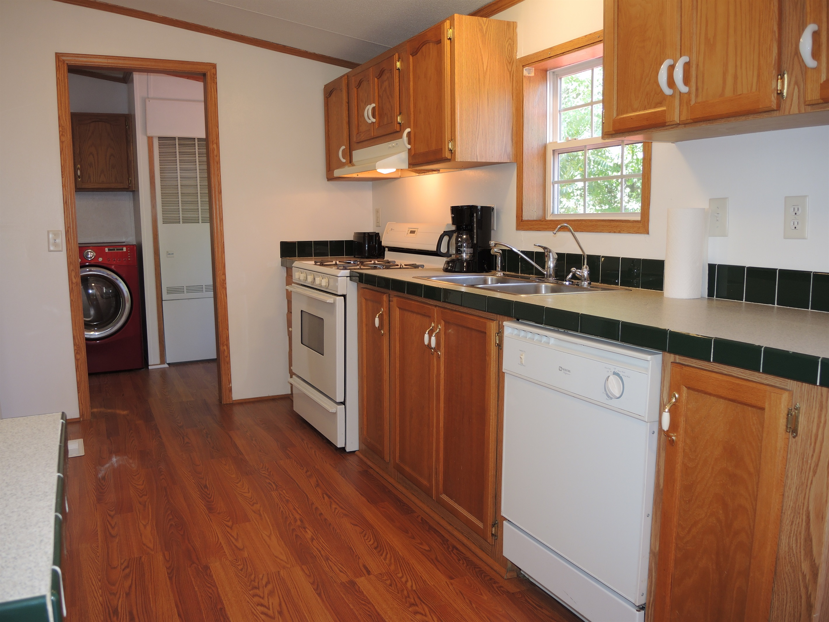 Kitchen w/ laundry beyond