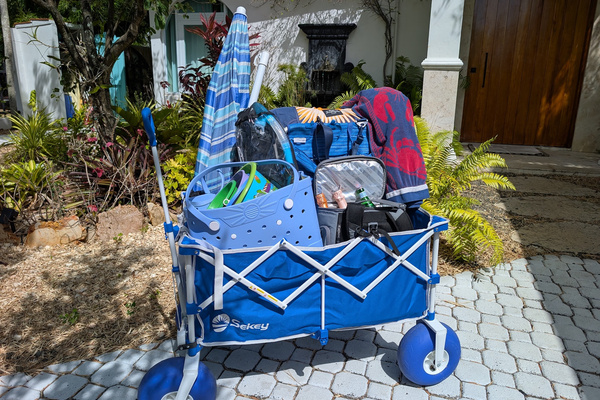 Blue beach wagon packed with complimentary gear including a beach umbrella, chairs, cooler, towels, and kids' sand toys provided for guests staying at Villa Coral in Dorado, Puerto Rico.