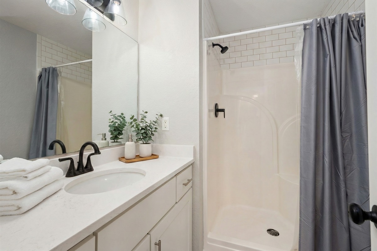 ML Bedroom 2 Bath - Modern and elegant bathroom with a sleek vanity and walk-in shower.