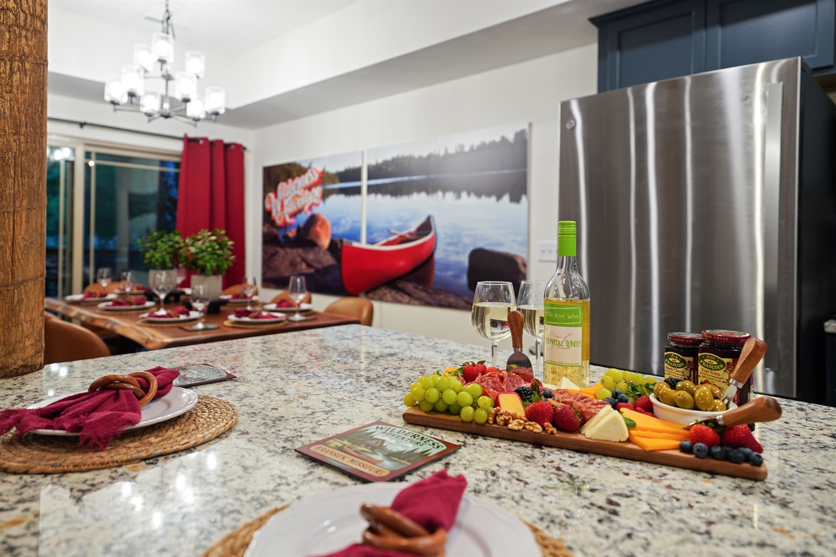The kitchen and large island counter is all connected to the dining table and outdoor seating