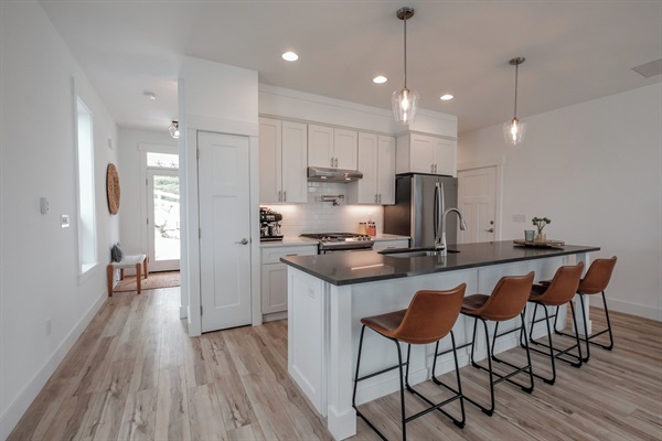 A bright, elegantly designed kitchen welcomes you with generous counter space and premium finishes. 