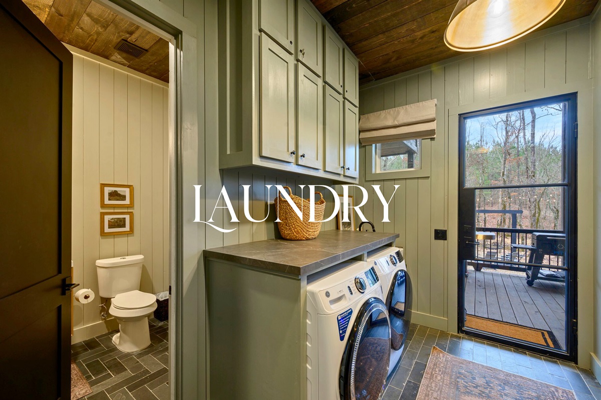 The laundry room features modern appliances and plenty of storage, making it easy to refresh clothes during your stay.