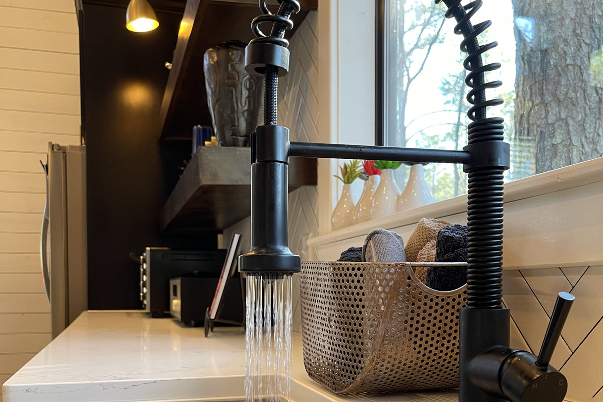 Elegant faucet to accent the concrete farmhouse sink.