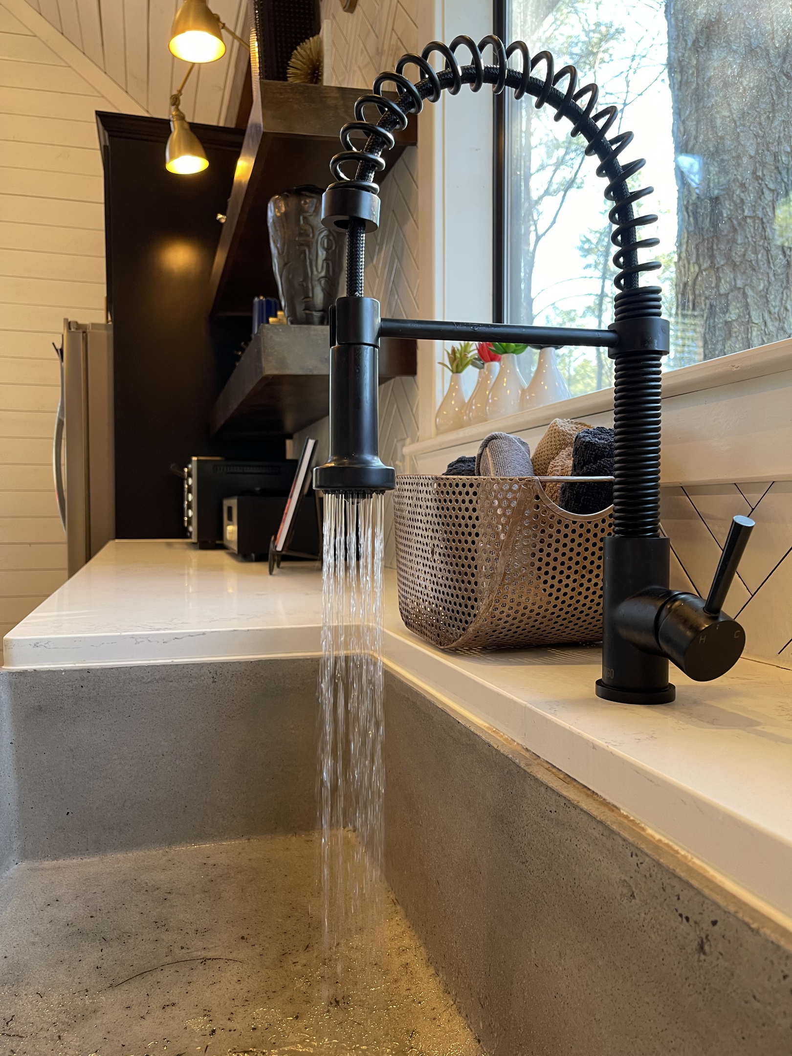 Elegant faucet to accent the concrete farmhouse sink.