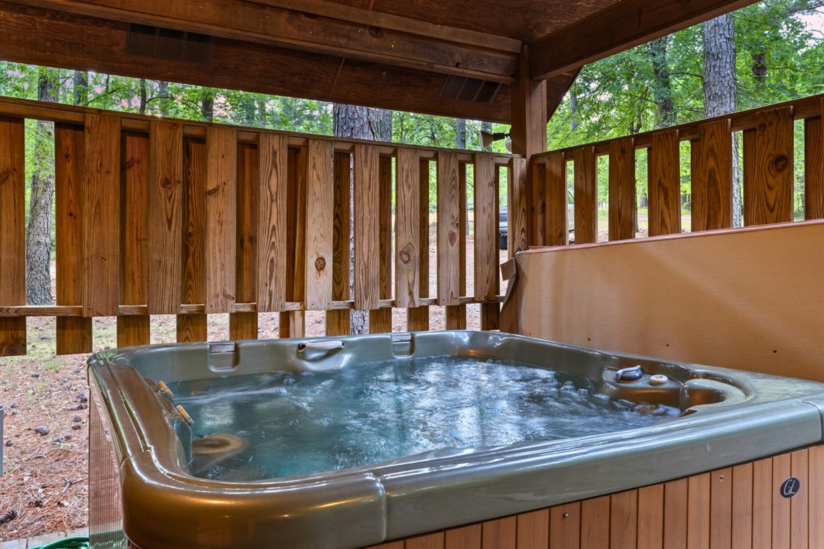 Soak away your worries in the private hot tub overlooking the woods.