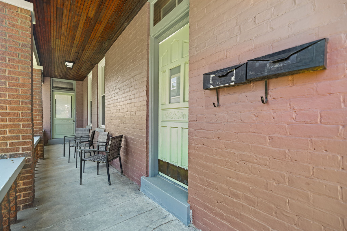 Pull in to a charming covered porch with brick and outdoor seating to enjoy a morning coffee