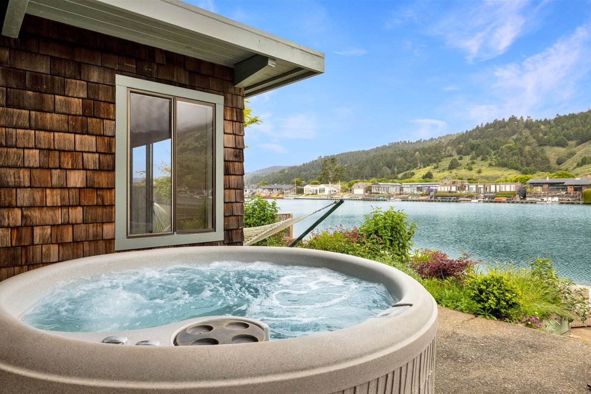 - Private hot tub with bubbling jets overlooking a scenic waterfront view  
- Perfect spot to relax while enjoying the fresh air and peaceful setting  
- Positioned just steps from the home for convenience and easy access  
