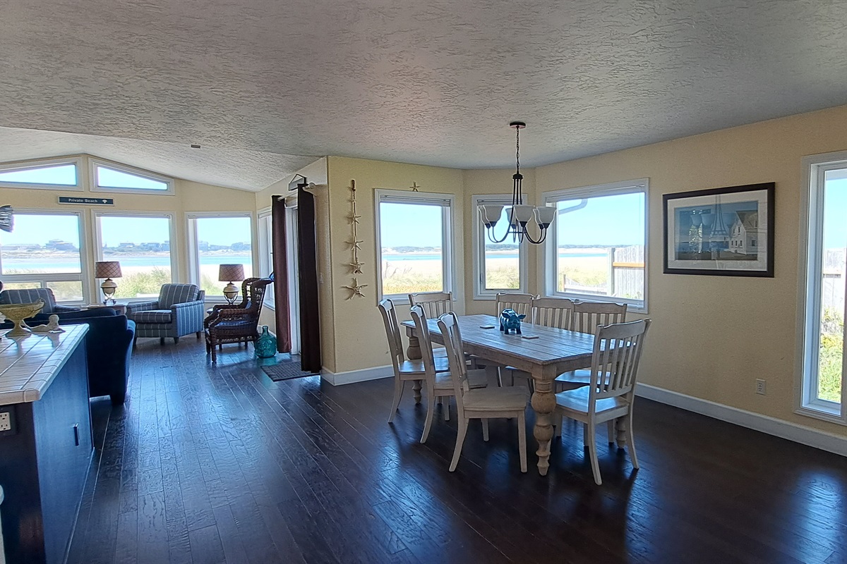 Open living, kitchen, and dining area surrounded by stunning views.