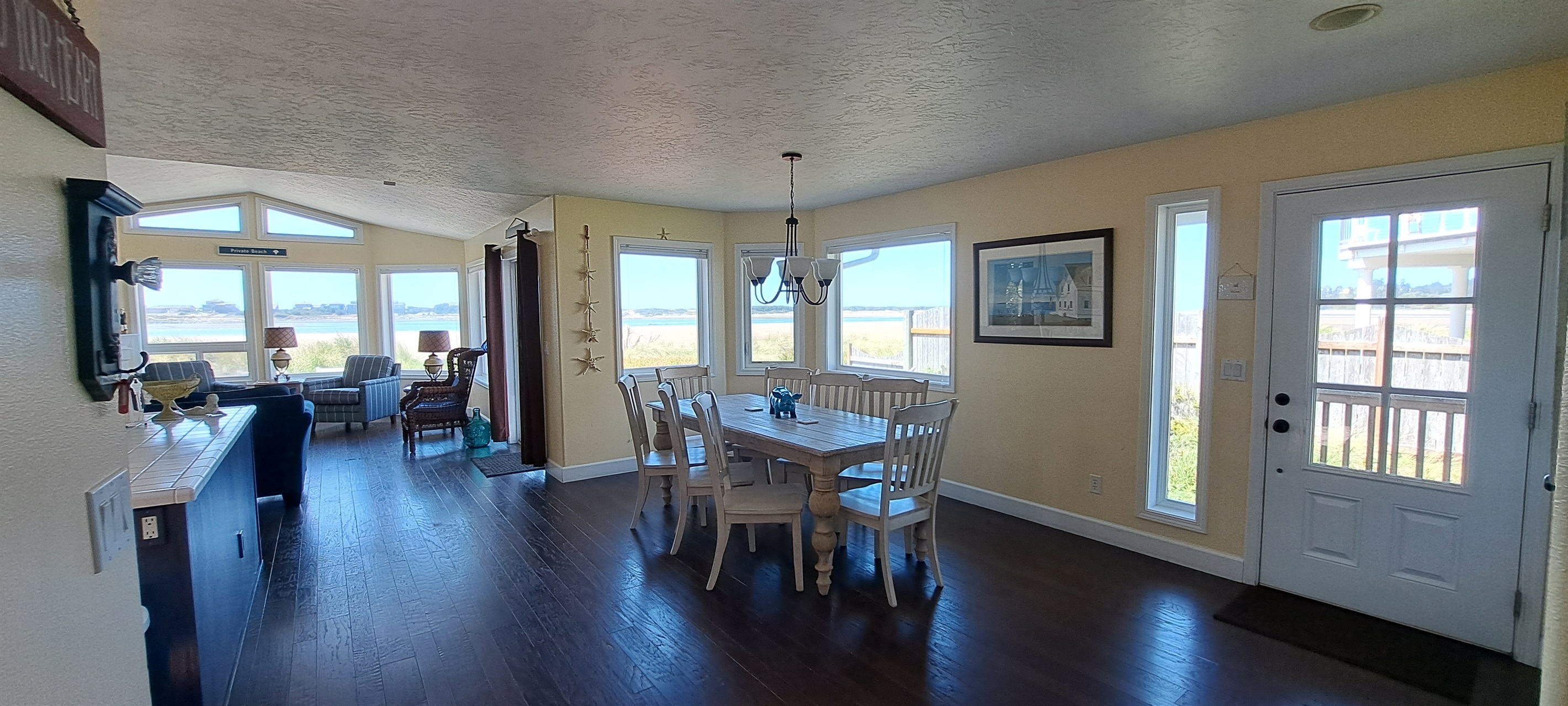 Open living, kitchen, and dining area surrounded by stunning views.