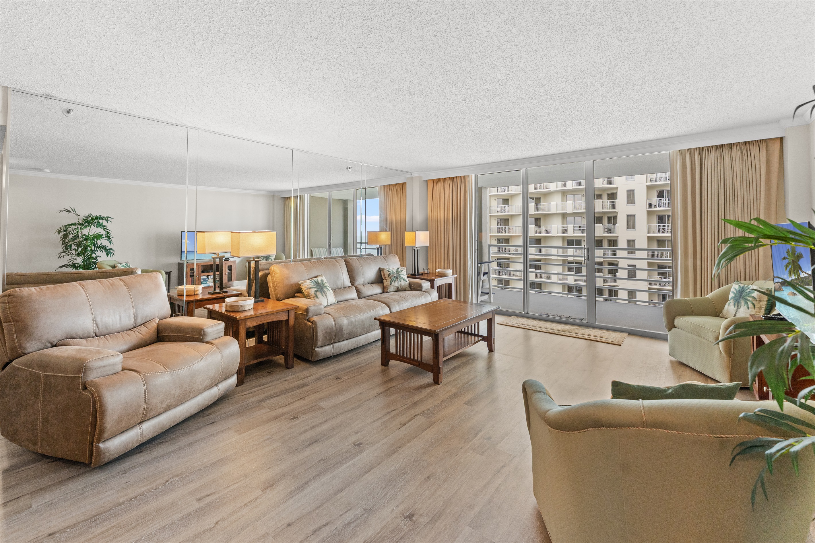 Spacious Living room with seating for everyone, large TV and balcony access