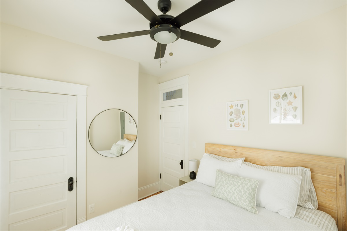 Large Queen Bedroom with extra seating, clothing storage.