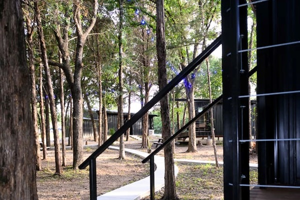 Entrance into your cabin and view of the Barn Owl cabin and bathhouse where you have your own private bathroom.