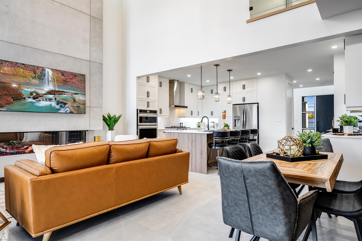 Orangish-brown accents in seating and cabinetry details create cohesion.