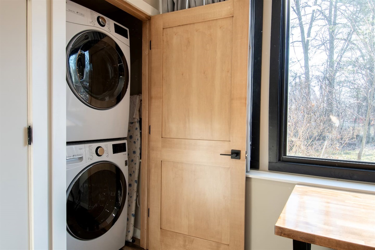 Laundry closet in apartment with supplied laundry detergent.