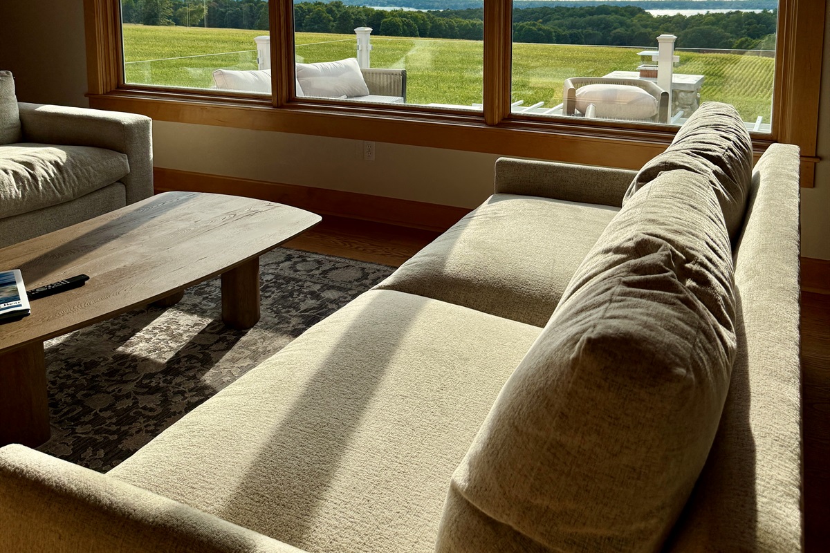 Relax in the oversize sofas in the living room with stunning panoramic views of Torch Lake, Grand Traverse Bay, Old Mission Peninsula and the Leelanau Peninsula. 