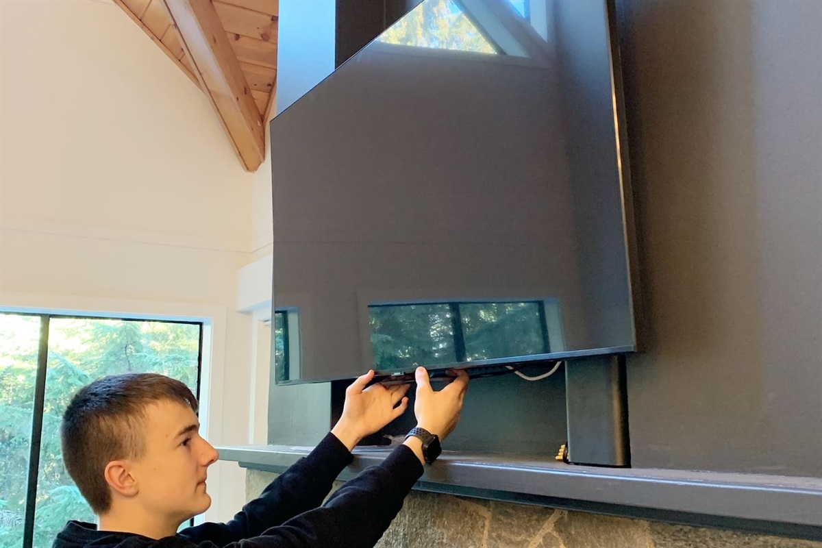 The 55" TV is on a movable mount to lower it for more comfortable viewing.