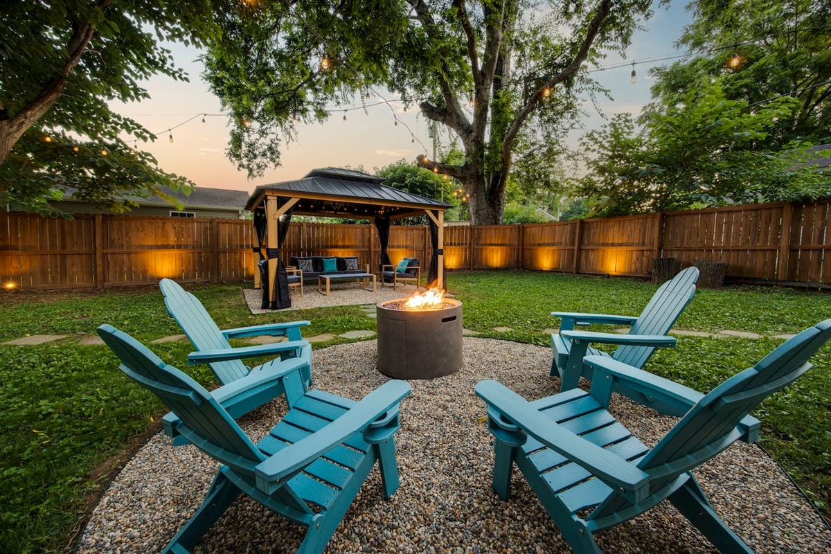 Backyard fire pit and seating area, surrounded by 6 foot privacy fence. Unwind, gather round, and enjoy your own oasis.