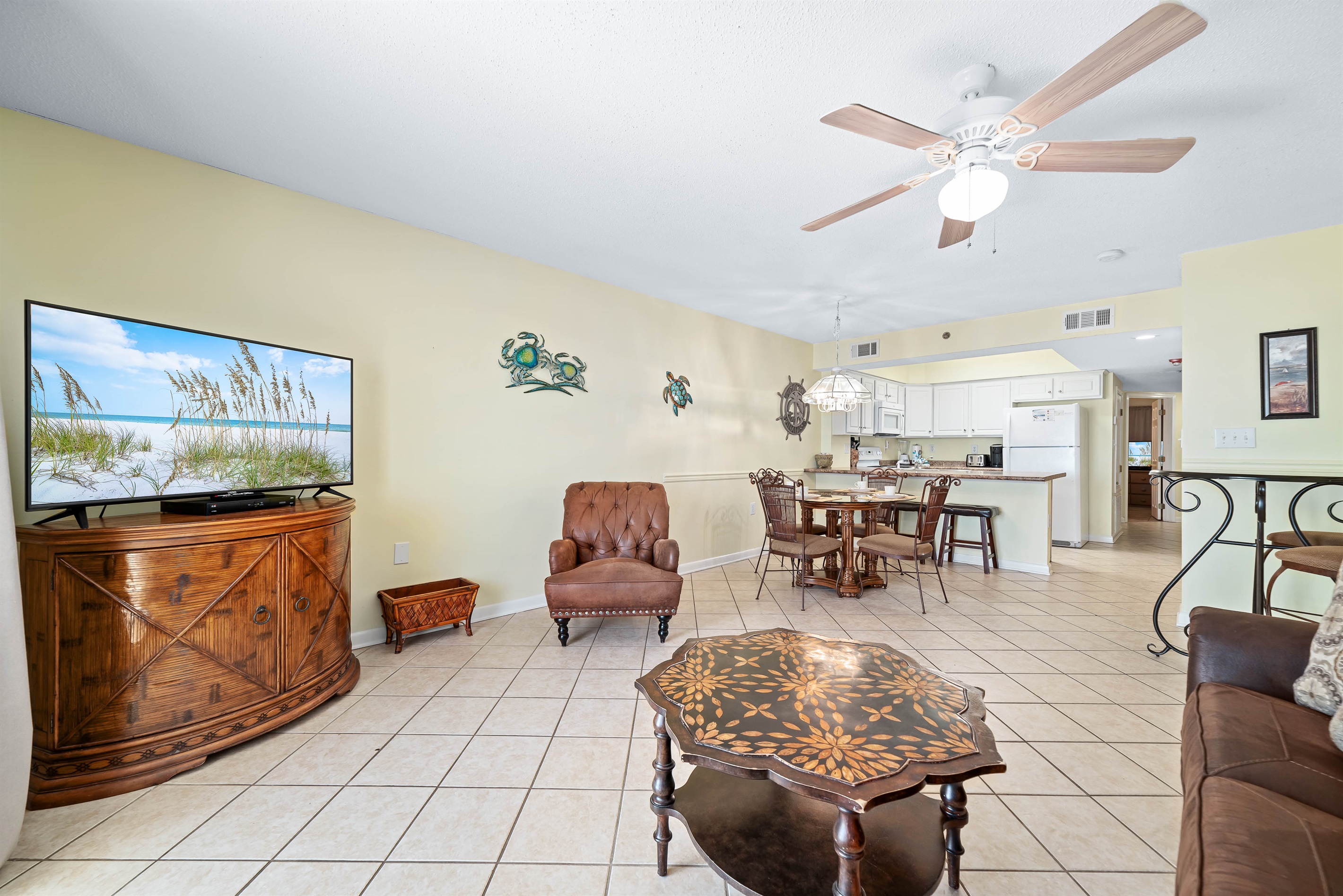 Subtle coastal touches and a neutral palette create a serene and relaxing ambiance in this open living and dining space.