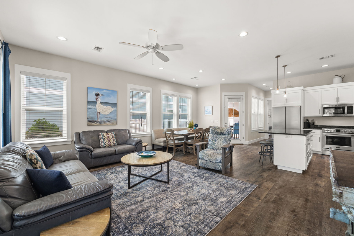 Bright coastal living room with brand-new 75” Smart TV (2026), comfortable seating & open family gathering space