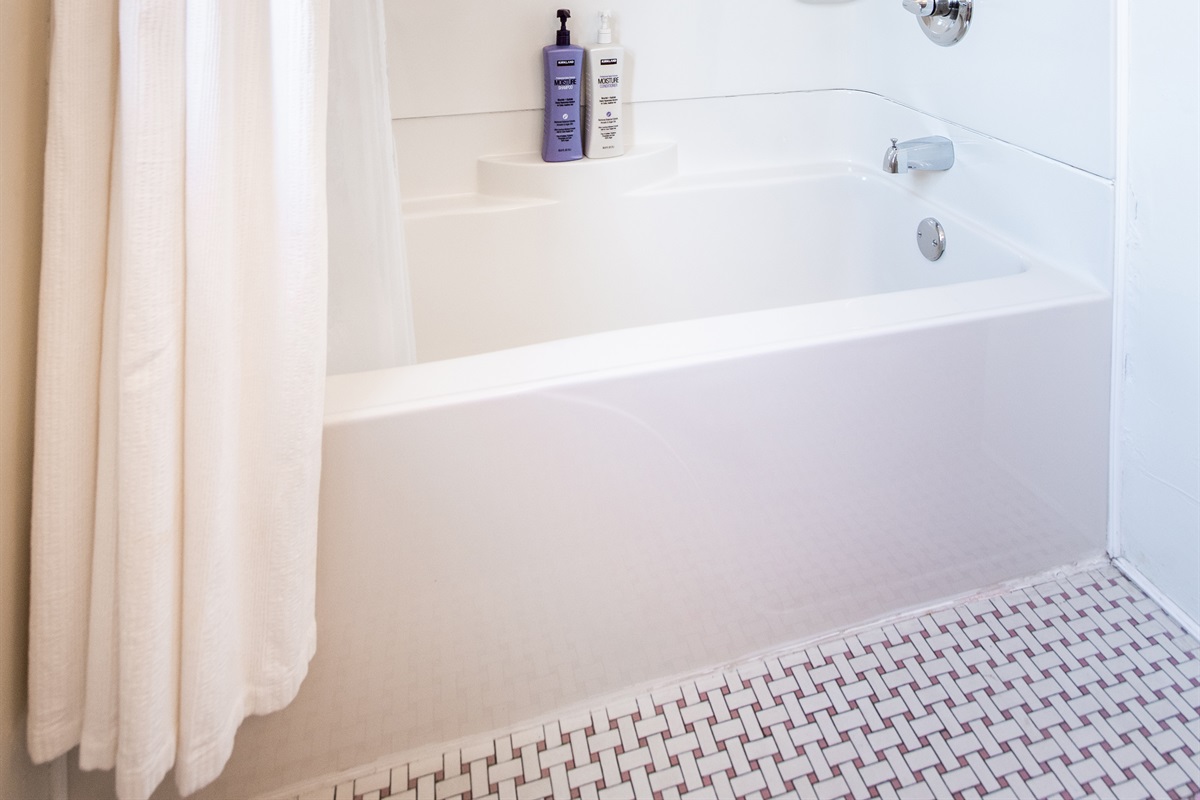 Full bathroom in hallway, tub/shower combo