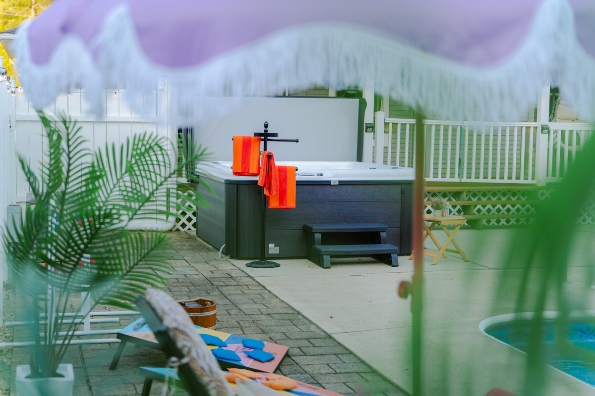 Enjoy year-round relaxation in the spacious hot tub overlooking the pool area